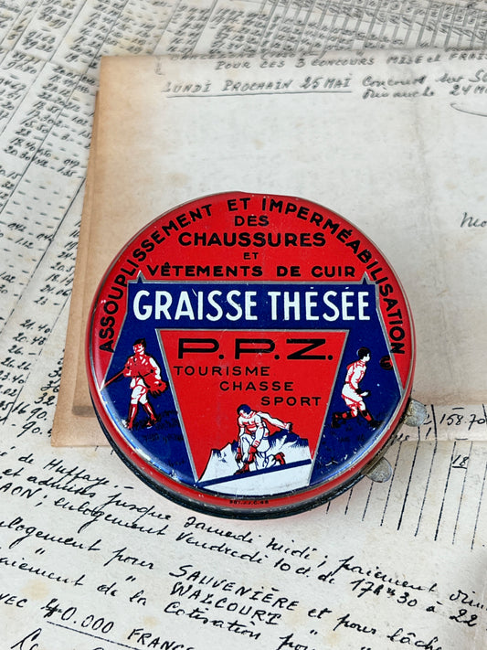 Ancienne boîte de cirage publicitaire en métal de la marque Graisse Thésée, objet de collection en fer blanc lithographié d'époque vintage.