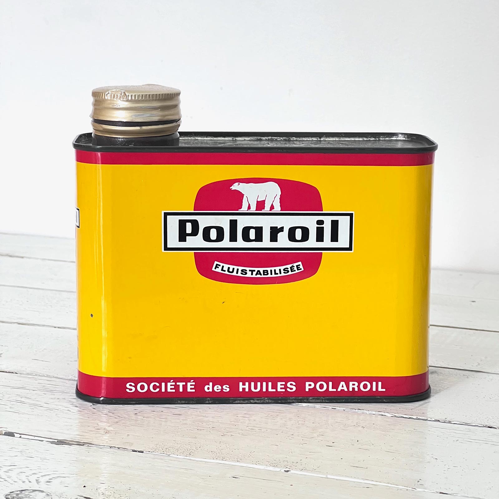 Ancien bidon d'huile Polaroil en tôle lithographiée jaune avec logo ours blanc, format 17 x 14,5 x 7 cm.