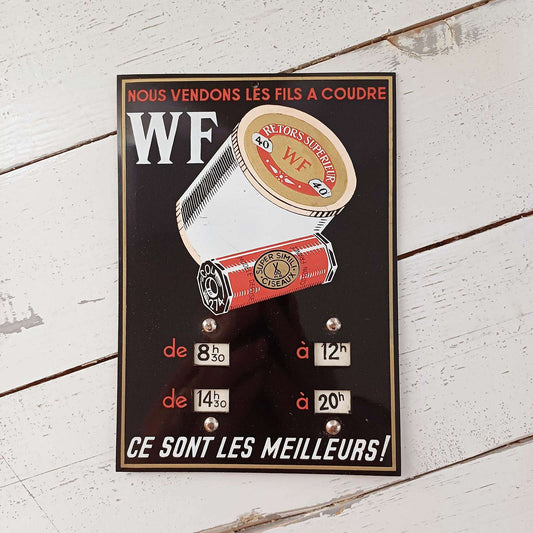 Plaque d’horaire en PVC pour fils à coudre WF, ancienne enseigne de mercerie en très bon état.