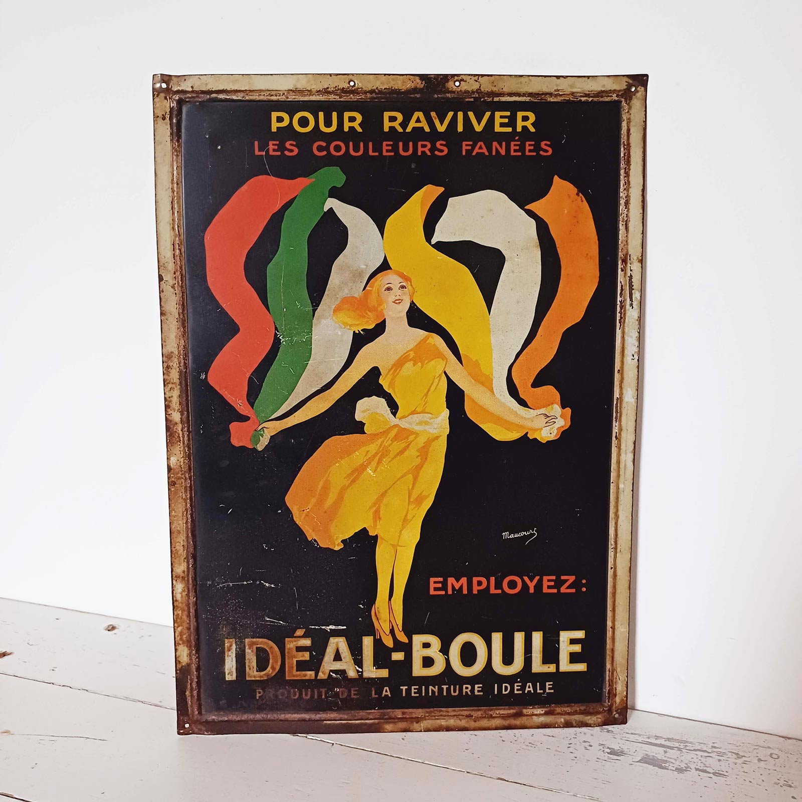 Tôle lithographiée gaufrée Idéal-Boule des années 1925, illustration signée Maucourt avec forte patine et traces d’usure.