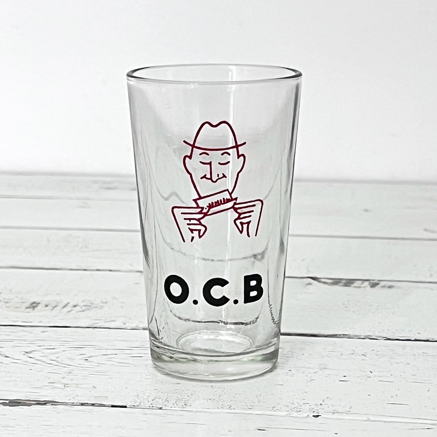 Ancien verre galopin publicitaire O.C.B. en verre transparent avec illustration du personnage emblématique des papiers à cigarettes.