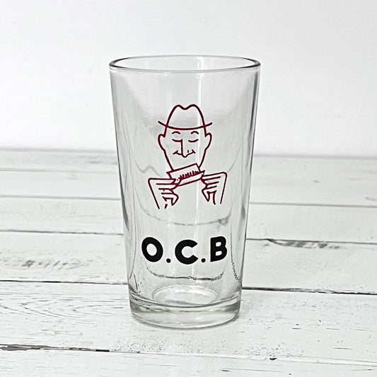 Ancien verre galopin publicitaire O.C.B. en verre transparent avec illustration du personnage emblématique des papiers à cigarettes.